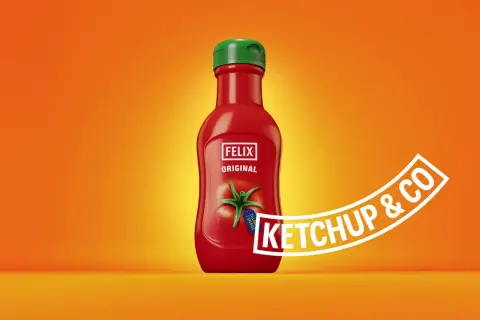 A red Felix Original ketchup bottle with a green cap on an orange background.