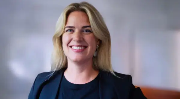 Amanda Oxell ler mot kameran, klädd i en svart kavaj och med blont hår.
