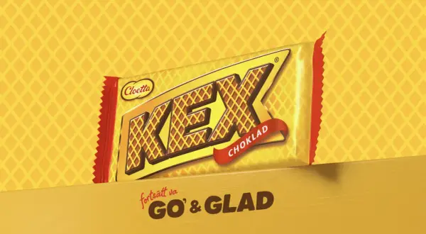 En gul och röd förpackning med texten "KEX CHOKLAD" och "fortsätt va GO' & GLAD".