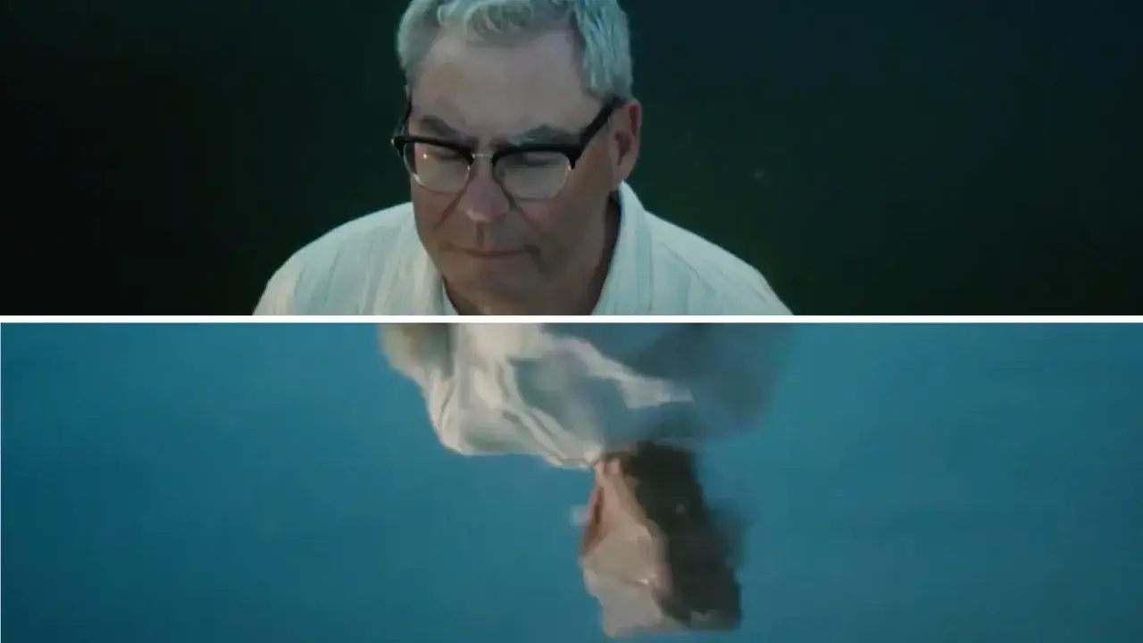 En man med glas&ouml;gon tittar ner. Under honom syns en person i vitt tyg som flyter i vatten. Trygg Hansa reklam.