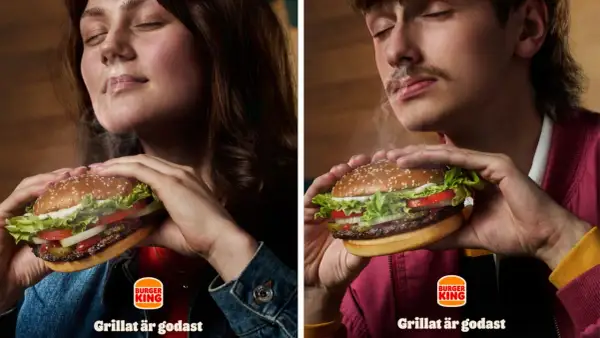 Två personer njuter av en saftig hamburgare från Burger King. Röken stiger från burgaren och skapar en härlig atmosfär.