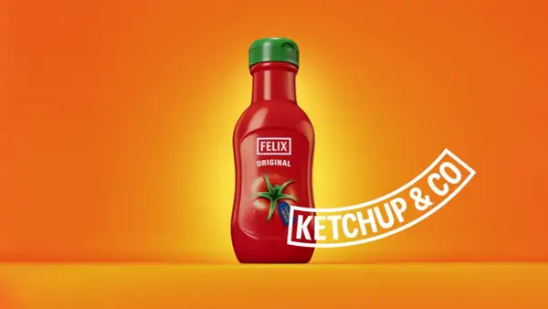 A red Felix Original ketchup bottle with a green cap on an orange background.