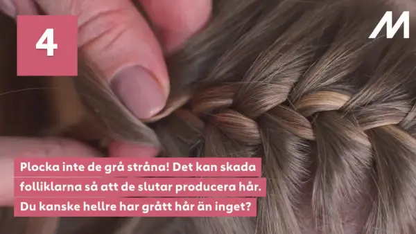 En fläta med vackra nyanser av grått och brunt, en naturlig grey blending. En hand drar försiktigt i en grå strå.
